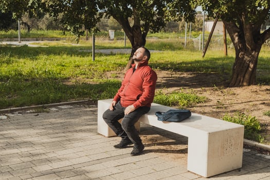 Man In The Park Of The City Relaxing On The Bench photo