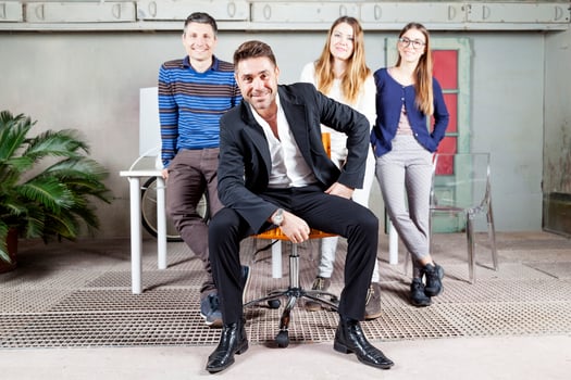 four young entrepreneurs posing in the new unfurnished office photo