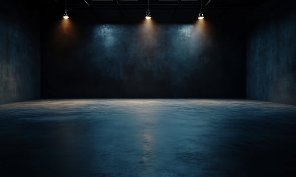 Dark, industrial space with spotlights. Empty room with rough concrete walls and floor photo