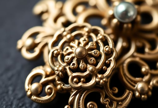 close up of a gold brooch with a pearl photo