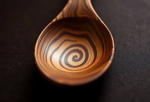 wooden spoon sitting on top of a table photo