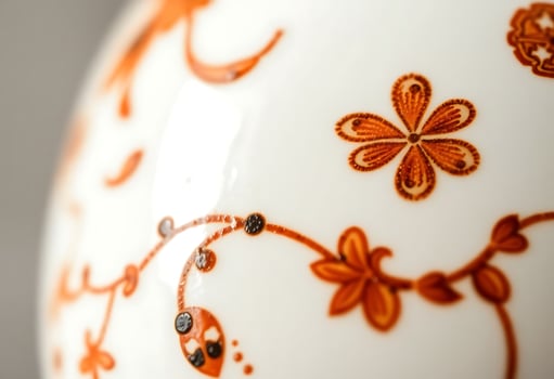 orange and white vase with a flower design on it photo