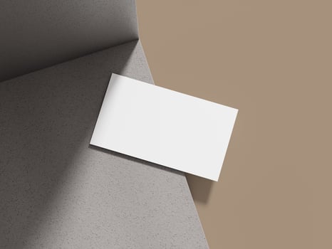 Business card mockup displayed on a grey cement block with soft lighting, creating an elegant backdrop for a professional design. photo