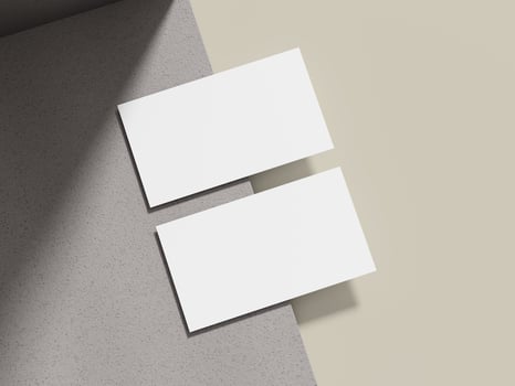 A simple business card mockup placed on a beige cement surface with a sleek shadow, ideal for showcasing minimalist brand logos. photo
