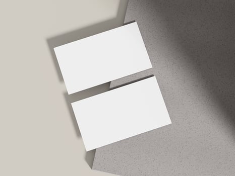 Business card mockup positioned on a grey cement block with lighting, perfect for modern branding presentations. photo