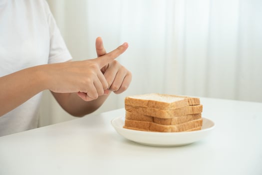 Wheat allergy gluten allergy, women refuse to eat bread, swollen mouth, swollen eyes, itchy rash, hives, stuffy nose, difficult breathing, itchy eyes, stomach pain, nausea, vomiting, diarrhea photo