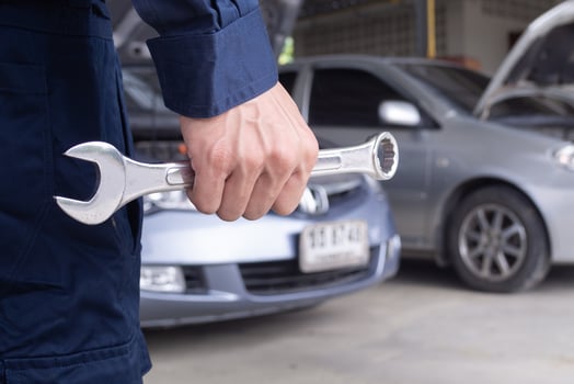 mechanic is do the annual car inspection. Car repair shop is ready to serve. Car mechanic inspects car engine problems technical inspection engine safety Maintenance Changing the engine oil photo