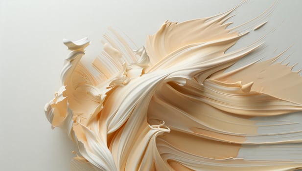 A white and cream colored liquid is flowing out of a brush photo