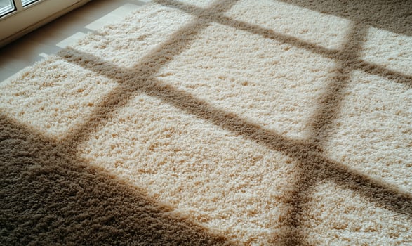 Beige carpet with sun shadows through window photo