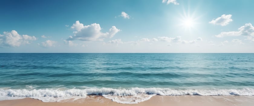 A tranquil ocean scene with gentle waves, blue water, and a bright sun shining in a partly cloudy sky, evoking relaxation, vacation, and seaside travel experiences. photo