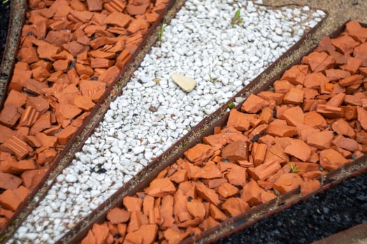 Geometric garden path with red and white stones photo
