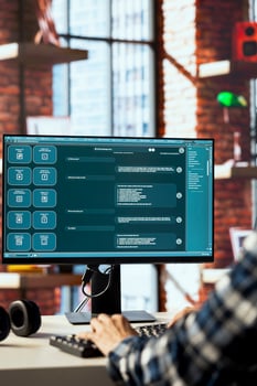 Person seated at desk communicating with AI LLM chatbot software in modern home office. Close up of large language model program interface on computer screen in bright apartment photo