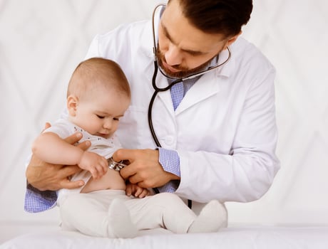 Medical Checkup Concept. Doctor Pediatrician Examining Baby Boy Listening To His Heartbeat Checking Heart And Lungs In Hospital. Sick Little Patient Having Appointment In Clinic. Child Healthcare photo