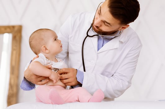Medical Checkup. Doctor Examining Baby Toddler With Stethoscope Listening To Her Heartbeat During Appointment Checking Heart In Hospital. Sick Little Patient In Clinic, Child Healthcare Concept photo