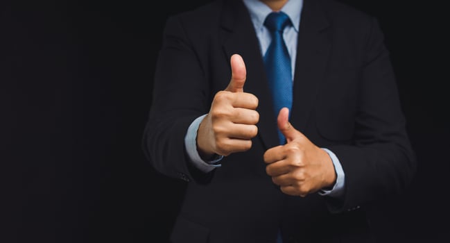 Close up of a businessman hand with thumbs up for best excellent services satisfaction client photo