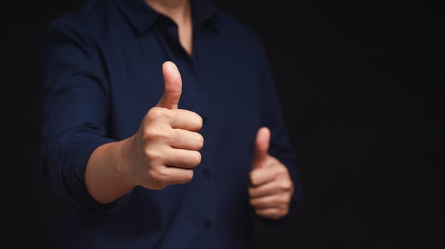 Close up of a man hand with thumbs up for best excellent services satisfaction photo