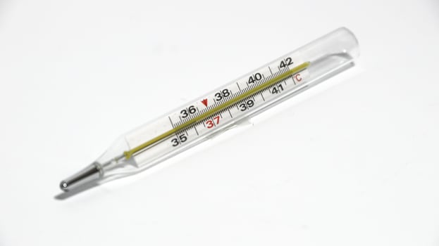 Close-up shot of clinical thermometer on white surface photo
