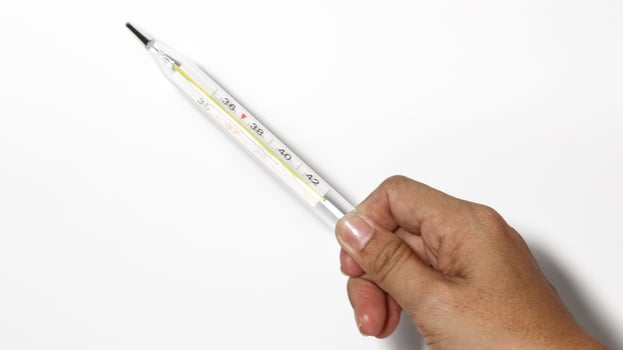 Close-up shot of clinical thermometer on white surface, photo