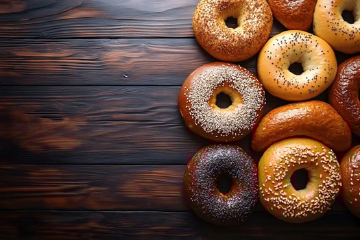 Assorted Fresh Bagels on Rustic Wooden Background Perfect for Breakfast and Bakery Promotions photo