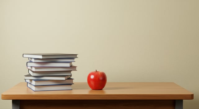A red apple next to a pile of books on a wooden desk, perfect for education. photo