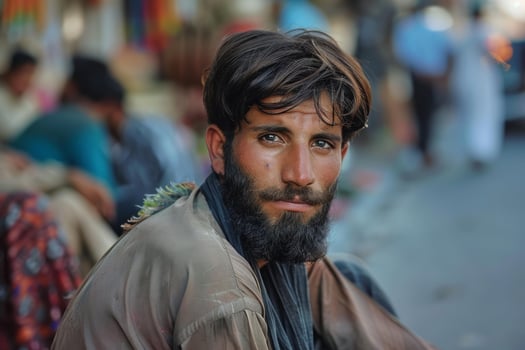 Portrait of afghan man sitting in a traditional market photo