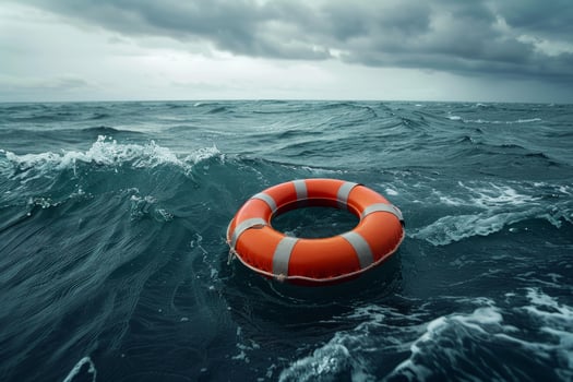 Lifebuoy floating on rough sea under stormy sky symbolizing hope and rescue photo