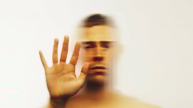 Abstract portrait of a man behind fluted glass, expressing depression, confusion, and isolation. Conceptual image of emotional struggle, mental health, and psychological pressure. photo