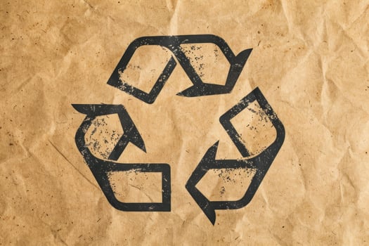 Recycling symbol promoting environmental awareness on crumpled paper photo