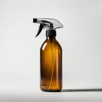 Amber glass spray bottle on white background with trigger sprayer photo