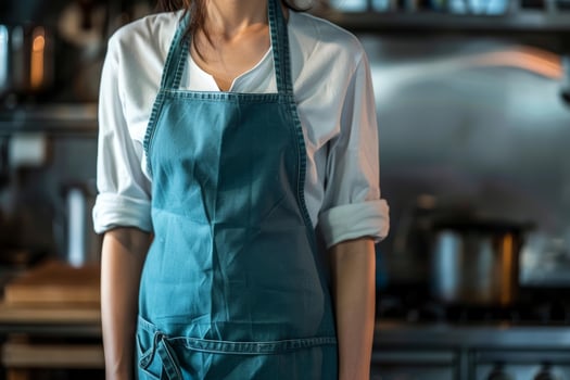Professional chef wearing apron in restaurant kitchen, ready to cook photo