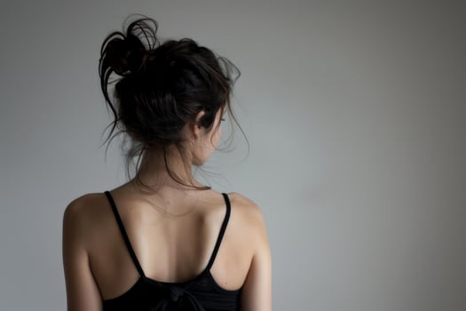 Young woman showing back with messy bun hairstyle photo