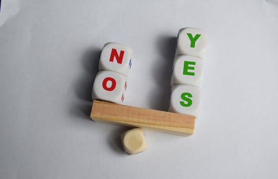 Yes or No inscription on wooden cubes on a seesaw with yess outweight no. The concept of positivy or positive attitude in life photo