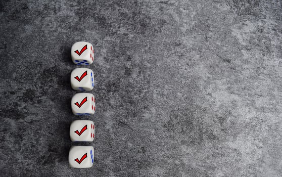 Wooden cubes or dice with check mark on the table. Checklist concept photo