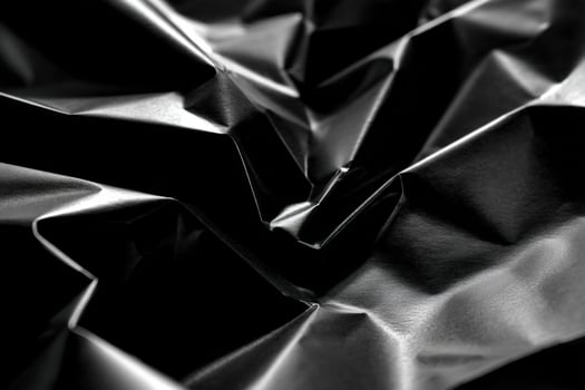Textured black material with folds and creases photo