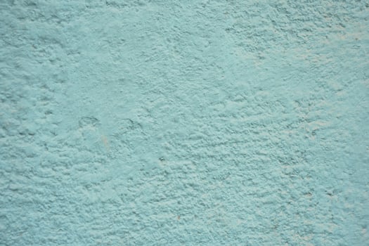 Textured turquoise wall with a rough finish in daylight photo