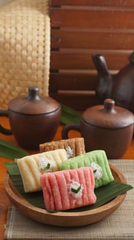 Gethuk, a traditional Indonesian sweet snack made from steamed and mashed cassava in various colors with grated coconut topping photo