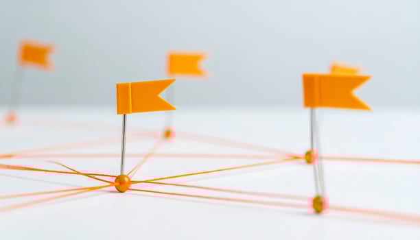 Orange Thread, Pins, and Flags Representing Stages of Goal Achievement and Planning photo