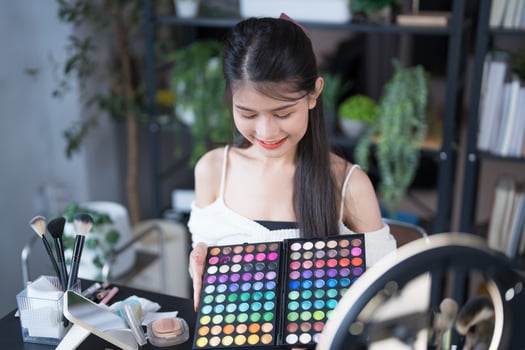 a woman is holding a makeup palette photo