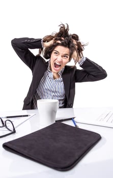 Stressed businesswoman screaming and pulling hair photo