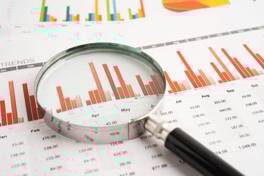 Magnifying glass on graphs paper photo