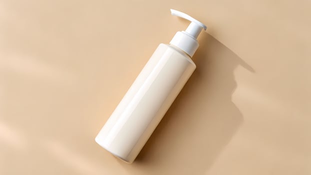 Cosmetic Bottle with Pump Dispenser on Beige Background photo