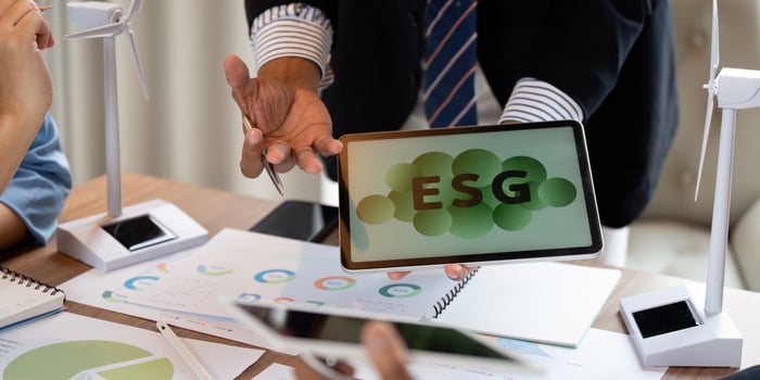 Sustainable ESG meeting featuring data sharing and wind turbine models photo