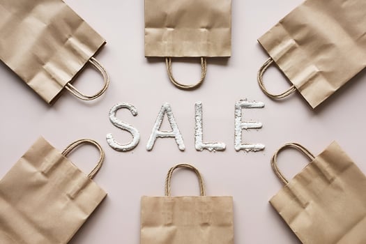 Six kraft paper bags around SALE text photo