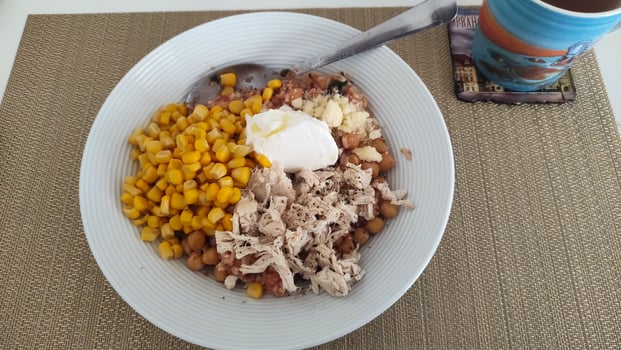 Healthy chicken chickpea corn and rice bowl with yogurt topping photo