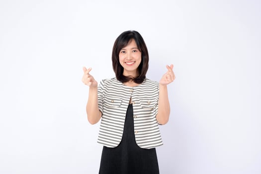 Southeast asian woman smiling and making heart signs with her fingers in bright advertising style photo