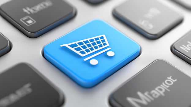 A blue shopping cart icon on a computer keyboard. photo