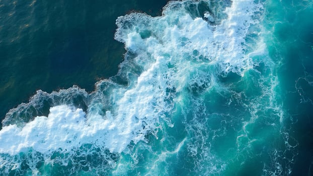 Aerial View of Ocean Waves Crashing Shore photo