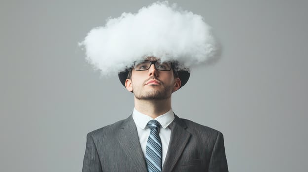 A man with a fluffy white cloud on his head, wearing a suit and tie, standing against a plain background. photo