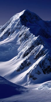Snowy mountain peaks bathed in twilight light photo