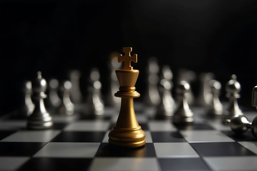 Golden king chess piece leading a strategic board game for victory in the dark photo